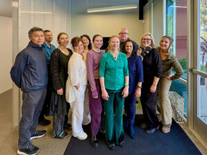 Group photo showing team members in monochrome outfits