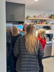 Team members grabbing a clue from the fridge