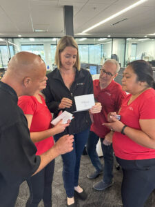 Team members huddled around a clue