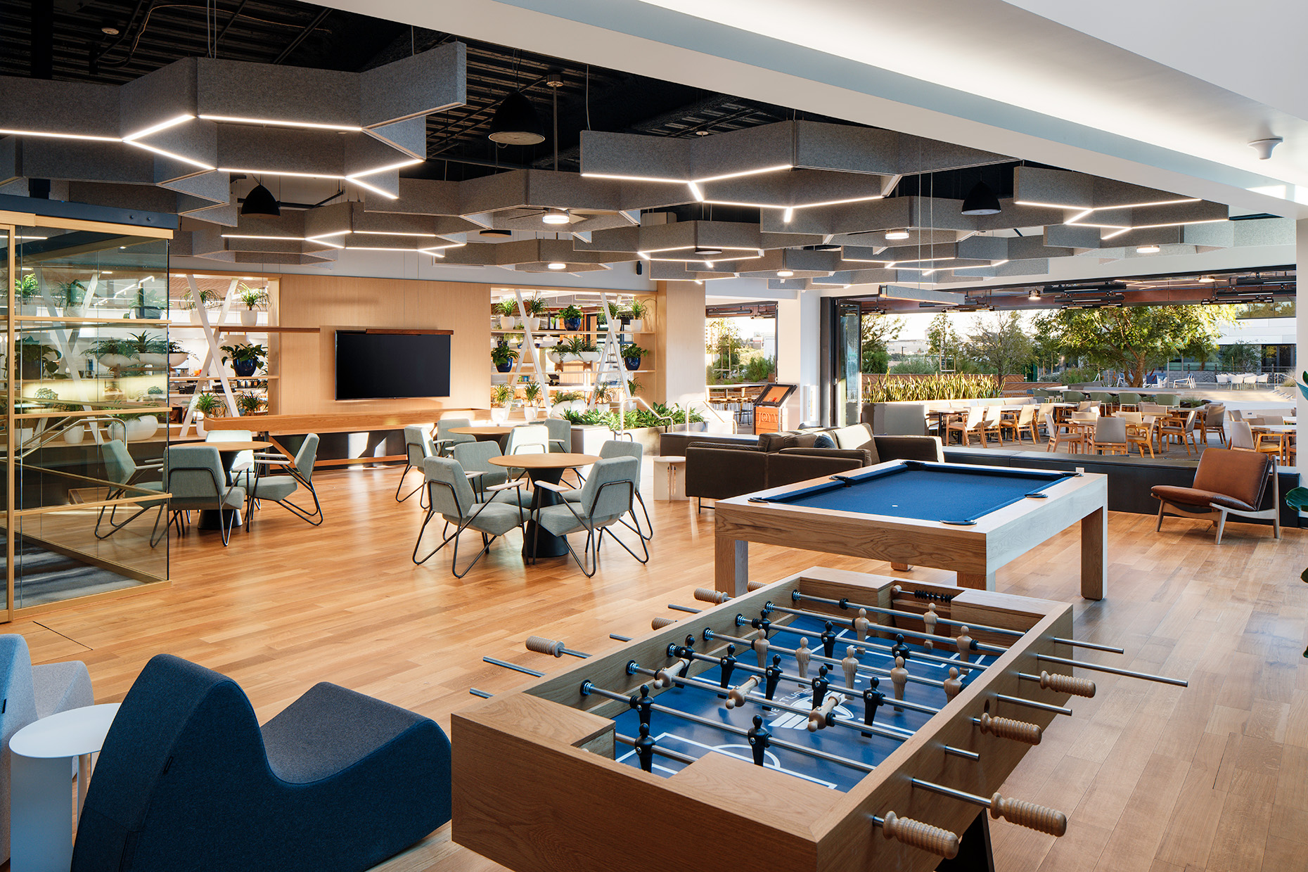 Interior view of indoor-outdoor campus amenities including games and collaboration space