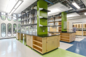 Interior view of a light-filled research lab with green columns in an existing historic building