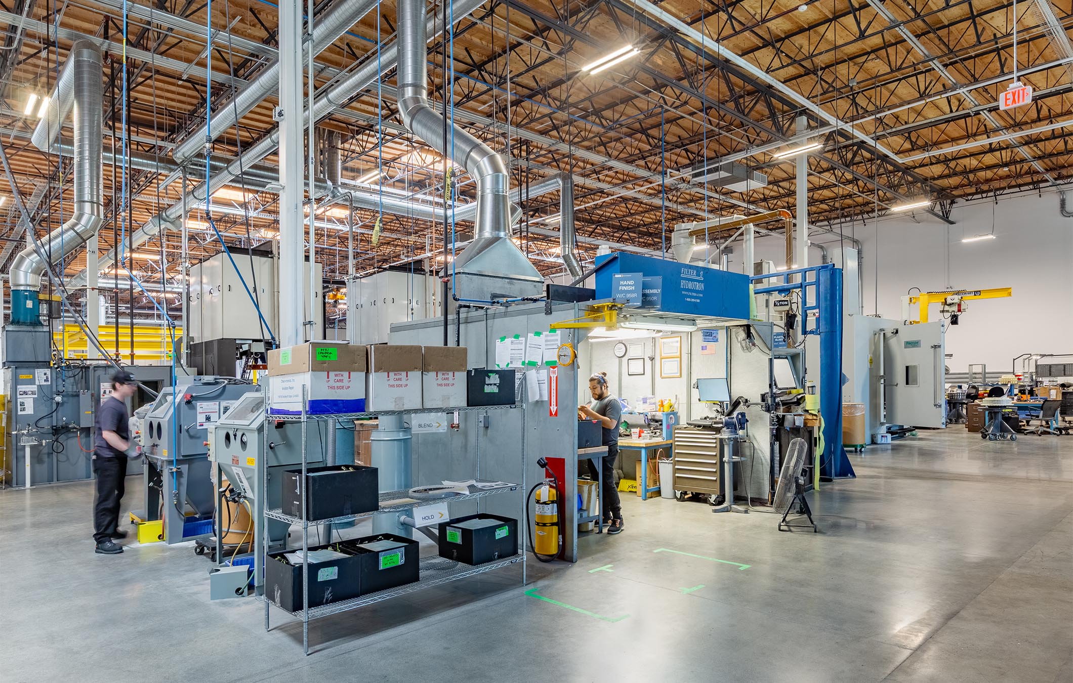 Wide-angle view of a high-bay space with aviation repair equipment