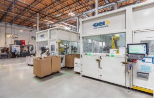 Wide-angle view of a high-bay space with automation equipment repairing aviation blades