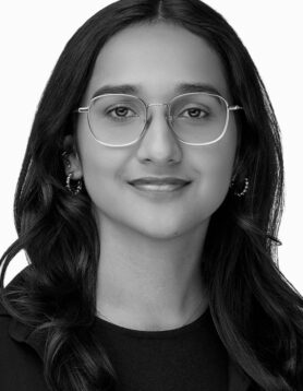 Daniella, Marketing Coordinator, smiling in black and white professional headshot