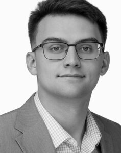 James Armendariz, Junior Designer, smiling in a black and white professional headshot