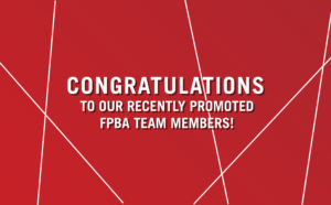 Ferguson Pape Baldwin Architects corporate graphic with a red background overlaid with thin, intersecting white lines that form a web-like pattern. In the center is a bold, white sans-serif capital letters: "Congratulations to our recently promoted FPBA team members!"