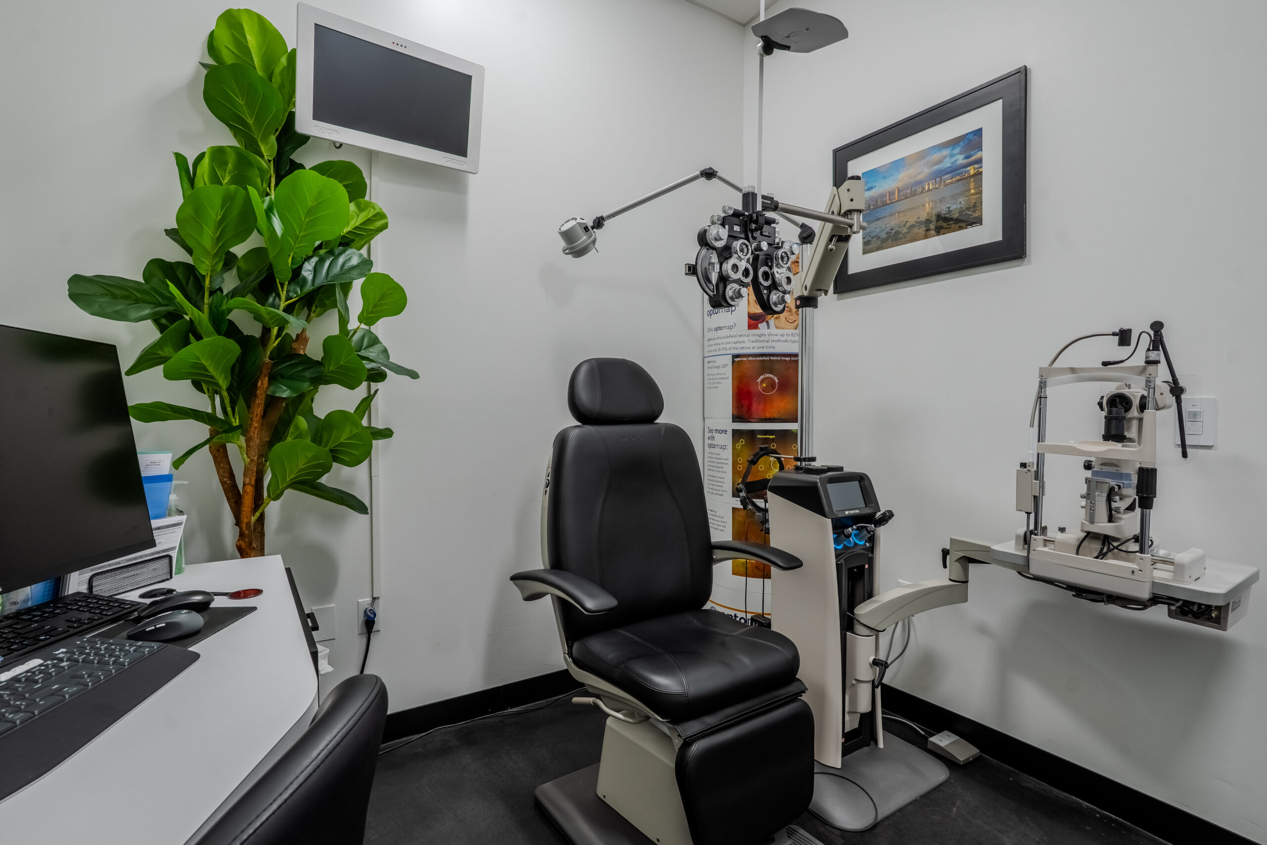 Exam room with phoropter and slit lamp equipment at San Diego Optometry, an FPBA-designed optometry office in San Diego, CA.