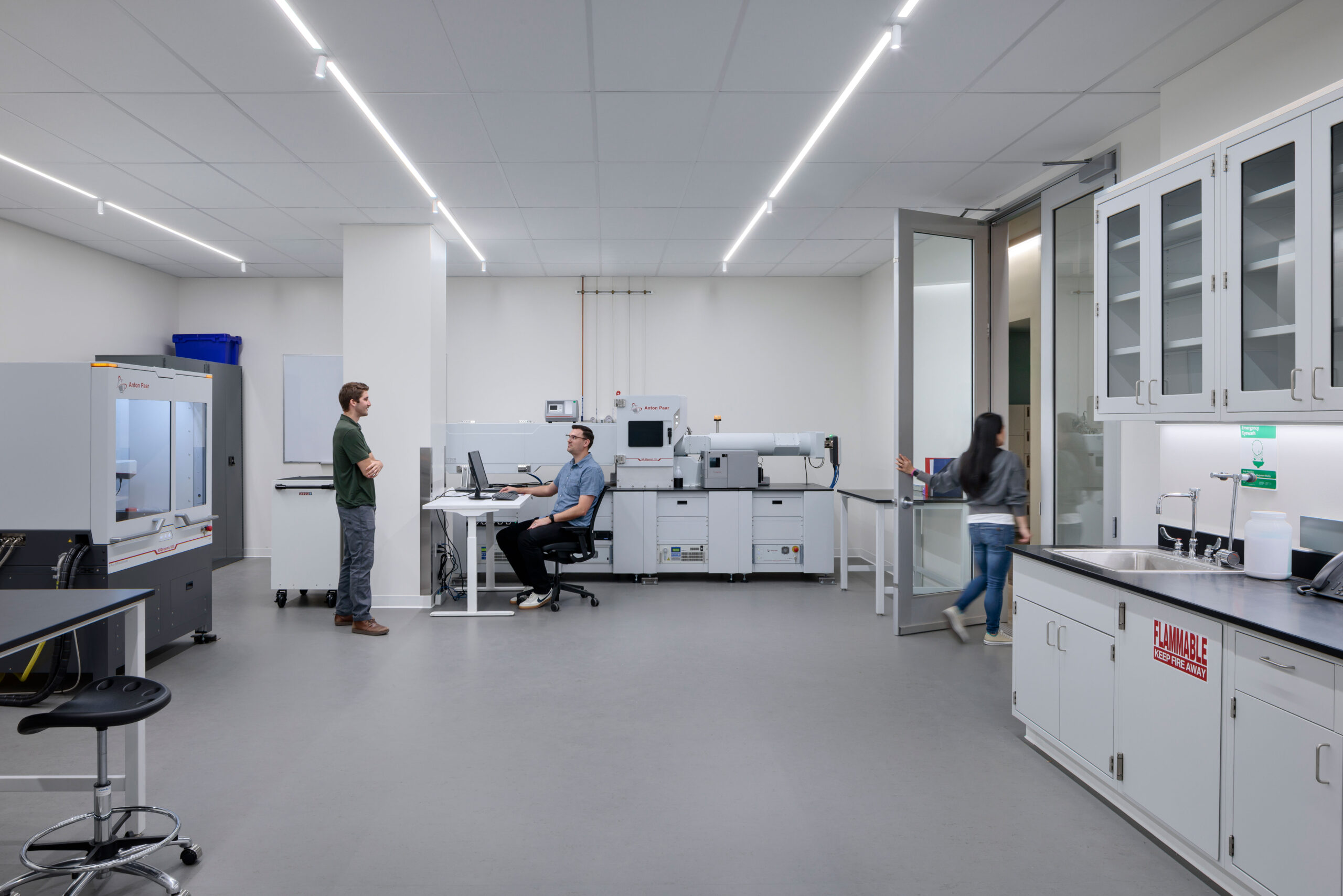 Researchers working at benchtop characterization instruments in a DEEP Lab laboratory suite, a clean, naturally lit space designed to support hands-on nanoscale research. A CAS Architects, an FPBA Co., and Jensen Architects education project.