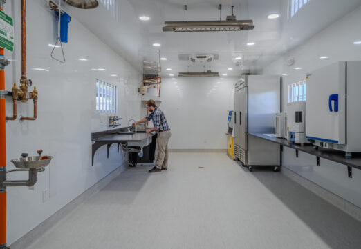 A researcher works at a sink inside SDSU's One Water Laboratory, an FPBA higher education project for San Diego State University in Mission Valley.