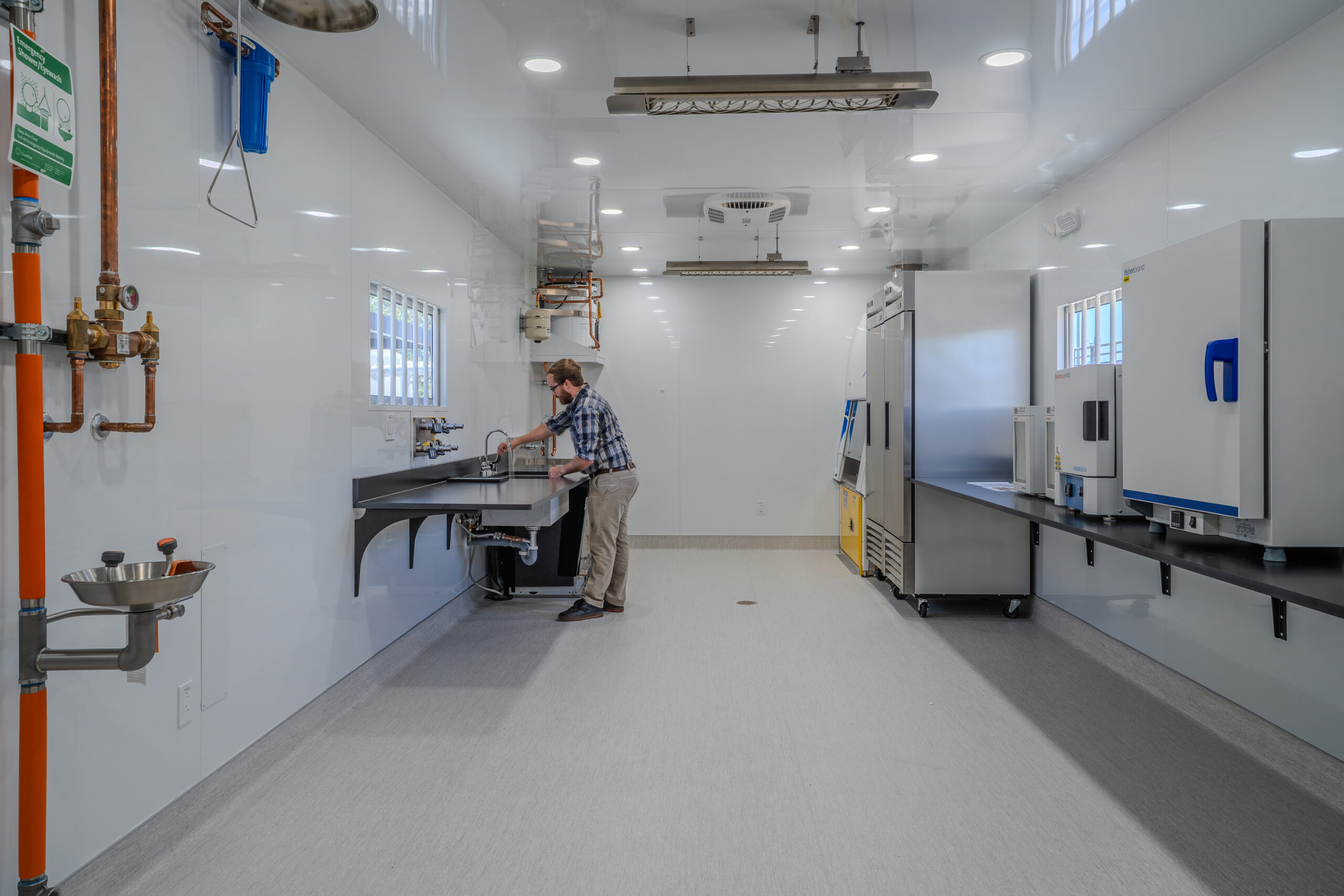 An individual works at a sink inside SDSU's One Water Laboratory, an FPBA higher education project for San Diego State University in Mission Valley.